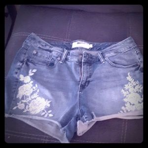I am selling a pair of denim shorts with flowers
